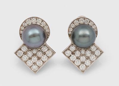 a pair of pearl and diamond earrings