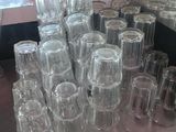 many glasses sitting on a table in a room