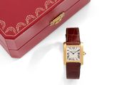 a red box with a gold watch and a red box with a gold watch