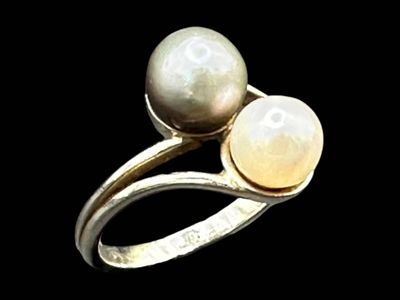 pearl and gold ring on a black background with a black background