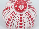 a red and white object on a white surface