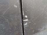 a close up of a car door with scratches on the side of it