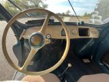 a steering wheel and dashboard of a car on the street