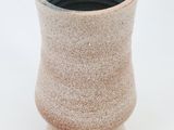 a small vase that is sitting on a white surface