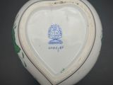 a white heart shaped box with a blue bird on it