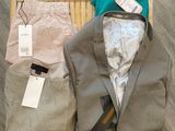 a suit jacket, pants, and a bag on the floor