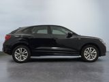 the black audi qx is parked in a garage