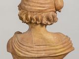 a bust of a man wearing a hat on a table