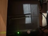 a computer that has a green light in the middle of it
