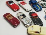a lot of toy cars and key chains on a table