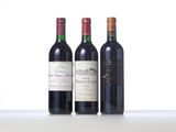 three bottles of wine are lined up on a table