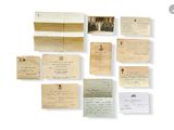 an image of a collection of old papers and letters on a white surface