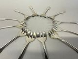 a lot of forks arranged in a circle on the table