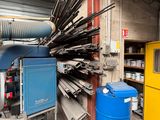 a large amount of pipes and barrels in a warehouse