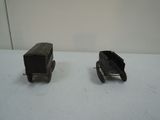 two toy trains sitting on a table next to each other