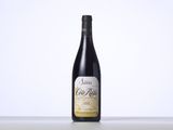 a bottle of red wine sitting on top of a table