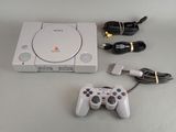 a white game console with a game controller next to it
