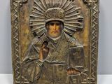 a close up of a metal plaque with a religious image on it