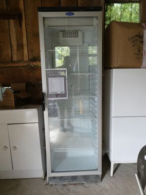 a refrigerator with a glass door in a kitchen
