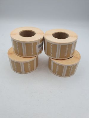 three rolls of brown and white labels on top of each other