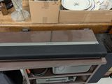 a sound bar sitting on top of a wooden shelf