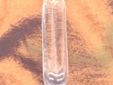 a clear glass bottle sitting on top of a wooden table