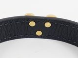 a close up of a black leather dog collar with gold studs