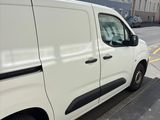 a white van that is parked on the side of the street