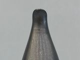 a black vase sitting on top of a wooden table