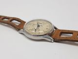 an image of a watch with a brown strap on a white surface