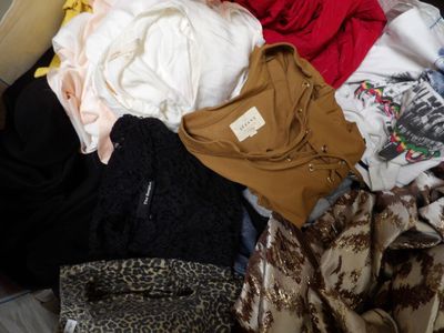 a pile of clothes on a bed in a room