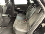 the back seats of a car with a remote control in it