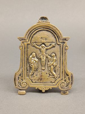 an antique brass figurine of a crucif with jesus on the cross