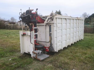 a dump truck that is sitting in the grass