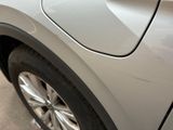 a close up of a car ' s door handle and tire