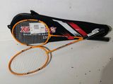 une raquette de tennis et un sac posés sur une table