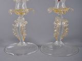 pair of clear glass candlesticks with yellow flowers and leaves