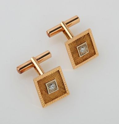a pair of gold and diamond cufflinks