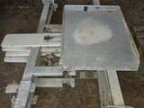 a metal table that is sitting in the dirt