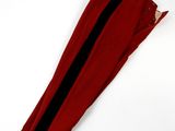 a pair of red pants with black stripes on them on a white surface