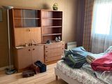 a bedroom with a bed, dresser, and bookcase in it