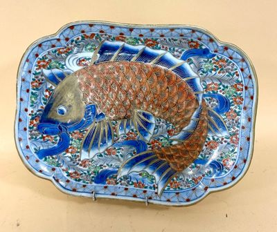 a blue and orange plate with a fish on it