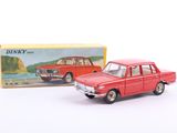 une petite voiture rouge à côté d'une boîte de petites voitures Dinky