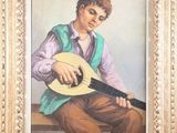 painting of a young man playing a guitar in a gold frame