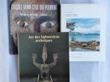 three books on a table with a blue cloth and a white sheet