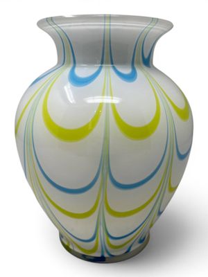 a white vase with a blue and yellow swirl design on it