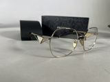 glasses are sitting on a table next to a pair of glasses