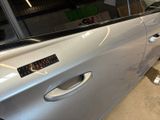 a silver car with a sticker on the side of it