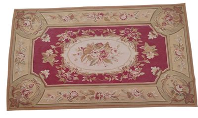 the rug is red and gold with a floral design on it