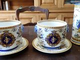 three cups and saucers sitting on a wooden table